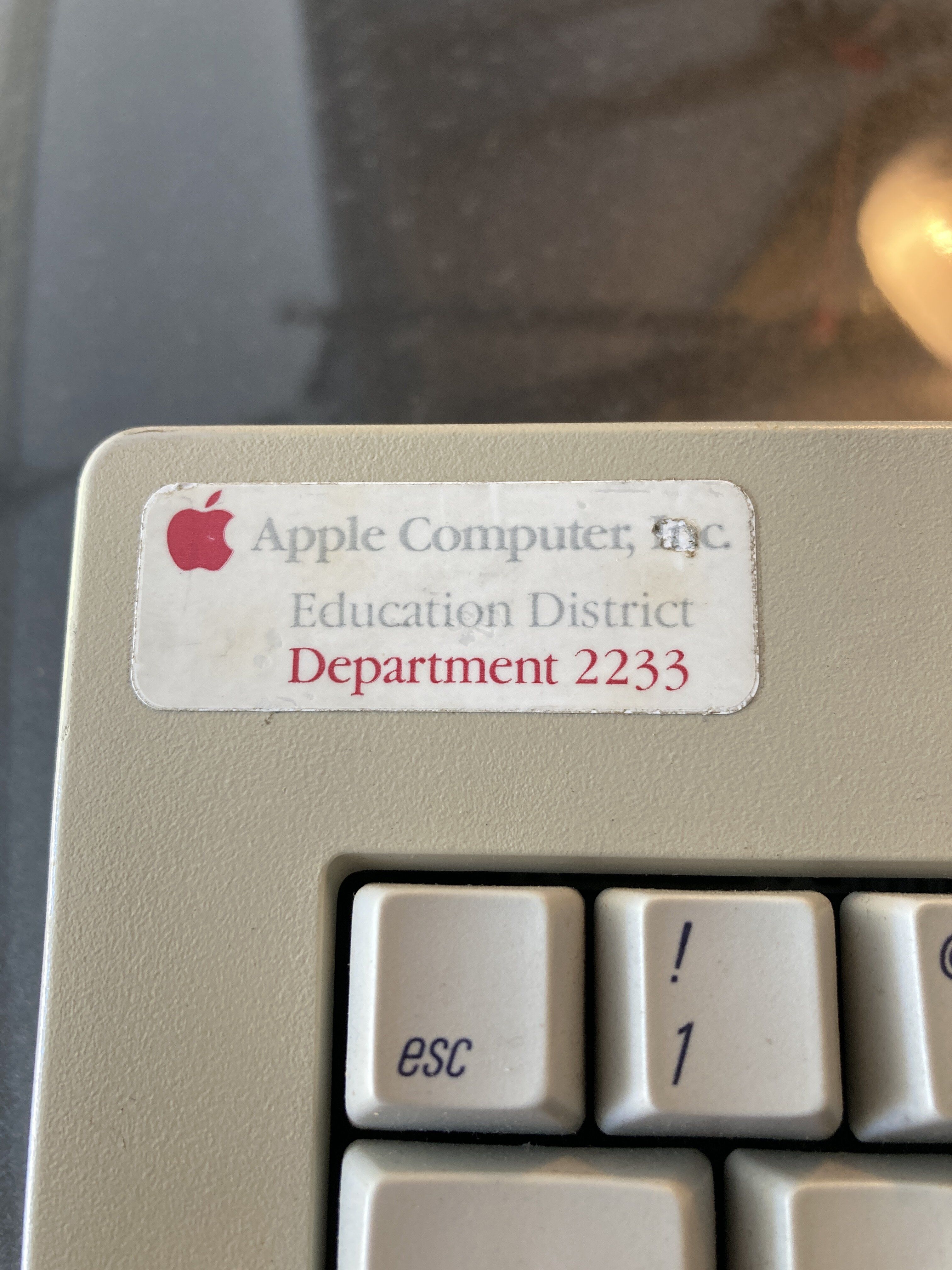 Apple Standard Keyboard with Apple Computer Inc Educational District Sticker attached.